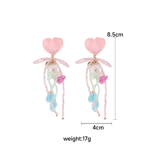 Detail view of pink heart bead tassel earrings with size 8.5x4cm and weight 17g specs