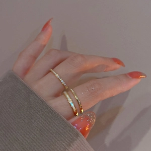 Close-up of triple layered gold plated rings with cubic zirconia pavé on a model hand