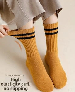 Detail of ginger wool crew socks with double black stripes and high-elastic knit texture