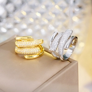 Macro detail of gold and silver multi-layer rings with micro-set zircons on jewelry box