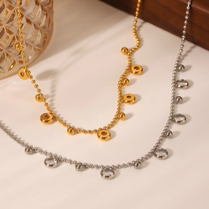 Elegant gold and silver beaded necklaces with zircon pendants on light surface
