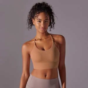 Detail of camel halter sports bra and purple leggings set with seamless matte fabric
