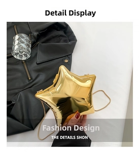 Detail of star-shaped acrylic evening bag with gold mirror finish and fine metal chain