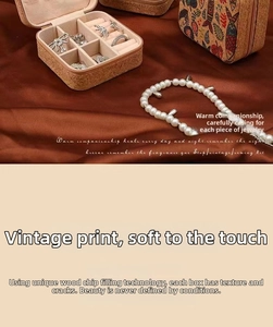 Detail view of vintage jewelry box with floral print, ring slots and silk background