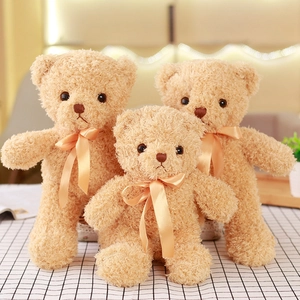 Three sizes of brown teddy bears with peach bows on a checkered tablecloth set