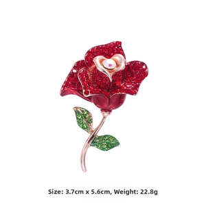 Detail showing red crystal rose brooch size 3.7cm by 5.6cm and weighing 22.8 grams
