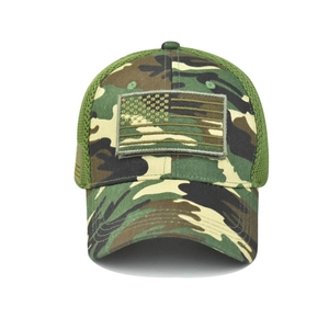 Detail of woodland camo baseball cap featuring tactical US flag patch and breathable mesh