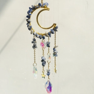 Detail of amethyst moon suncatcher featuring iridescent crystals and golden star charms
