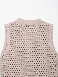 Detail of oatmeal knit vest showing hollow-out texture and round neck stitching