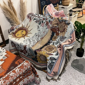 Detail of bohemian woven blanket with sunflower pattern and fringed edges in outdoor camp
