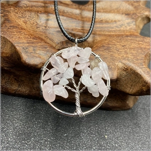 Detail of tree of life pendant with pink natural stones and silver wire wrapping