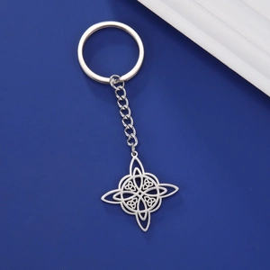 Macro detail of a polished silver stainless steel Celtic knot pendant on a keychain