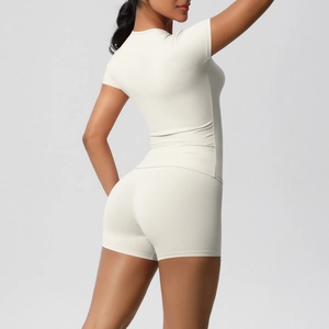 Slim fit cream athletic set featuring short sleeve t-shirt and cycling shorts for women