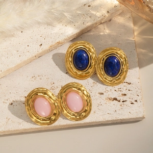 Vintage gold earrings with oval lapis lazuli and pink stones on a natural stone base