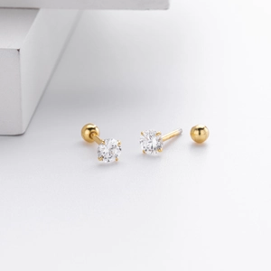 Macro detail of gold S925 sterling silver stud earring with zircon and screw ball back