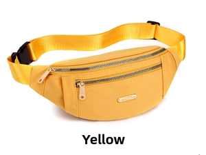 Detailed view of yellow nylon sports waist bag with dual zippers and adjustable strap