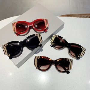 Cat-eye fashion sunglasses with gold metal stripe accents in multiple trendy colors
