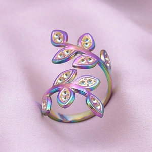 Detailed macro view of an adjustable leaf ring with iridescent finish and tiny crystals