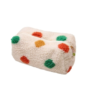 Plush polka dot makeup bag in cream fleece with colorful pompoms and floral zipper