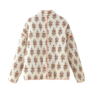 Back view of a white quilted floral jacket featuring ethnic prints and orange piping trim