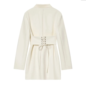 Dettaglio dell'abito blazer color crema con allacciatura regolabile in vita con occhielli