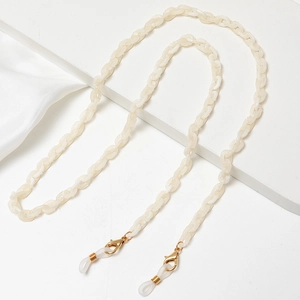 Detail of cream acrylic chain links with gold lobster clasp and silicone glasses loops