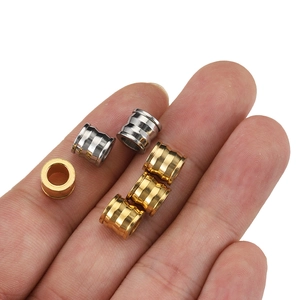 Golden and silver stainless steel spacer beads for DIY jewelry making on white background
