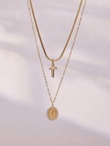 Detailed view of gold double layer necklace with cross and Mary medallion with zircons