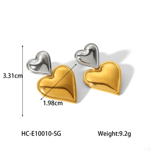 Detailed view of two-tone heart earrings with gold and silver finish and dimensions