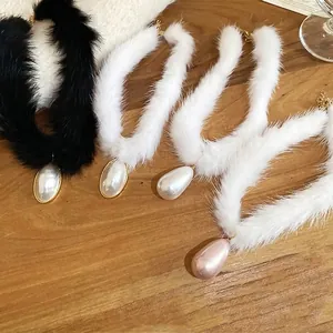 Elegant plush choker necklace featuring teardrop pearl pendants in black and white fur styles
