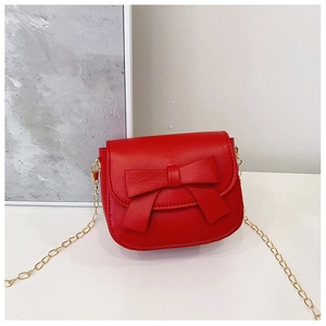 Close-up of a bright red mini shoulder bag featuring a cute 3D bow and gold chain strap