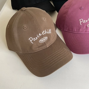 Detail of embroidered Paris Chill Radio logo on multi-color cotton canvas baseball caps