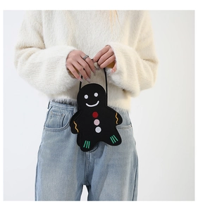 Detail of a black gingerbread man felt handbag with colorful embroidery and soft texture