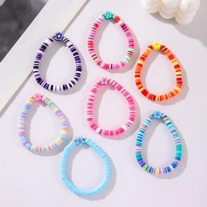 Bohemian multi-layer colorful clay bead bracelet set with floral charms on soft background