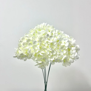 Close-up of artificial white hydrangea bouquet with dense petals for wedding decor