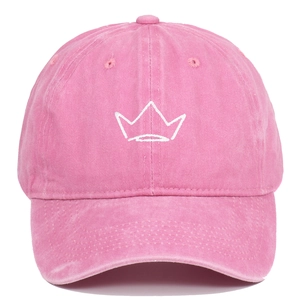 Close-up of pink washed cotton baseball cap with white embroidered crown and retro finish