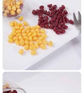 Macro view of realistic yellow and dark red wax beads for DIY miniature food models