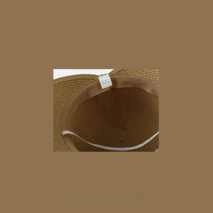Detailed interior of a 100% paper straw hat with sweatband and adjustable drawstring