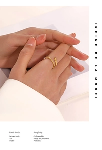 Close-up of a textured gold snake-shaped open ring worn on a finger with elegant styling