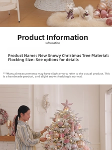 Detail of pink ornaments and warm lights on a snowy white flocked Christmas tree