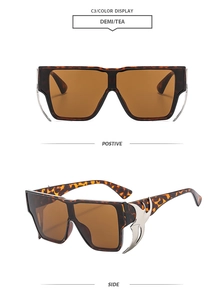 Detail view showing oversized tortoiseshell sunglasses with silver flame metal accents