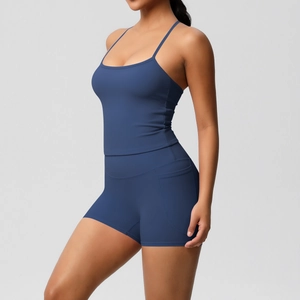 Detail of navy blue yoga set showing side pockets on high-waist shorts and thin straps