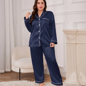 Navy blue satin pajama set for women featuring long sleeves with white piping and long pants