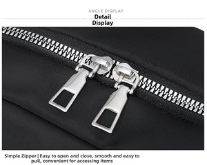 Detailed macro view of high-quality dual silver metal zippers on black casual backpack
