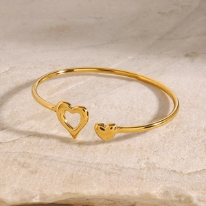 Minimalist gold stainless steel open heart bracelet with solid and hollow heart motifs