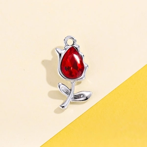 Detailed macro view of a red tulip pendant with silver alloy frame for DIY jewelry