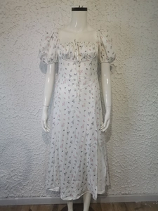 Detail of puff sleeves and drawstring tie neck on a white floral print summer dress