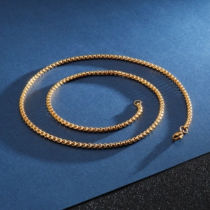 Mens gold box chain necklace made of stainless steel displayed on a dark background