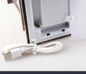 Detailed view of the dual power supply system showing battery compartment and USB cable