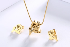 Detailed view of gold-plated rose necklace and earrings set with delicate snake chain
